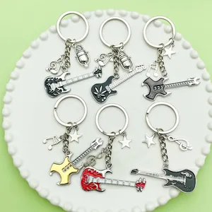 Close-up of various music themed keychains with guitar, music note and microphone charms.