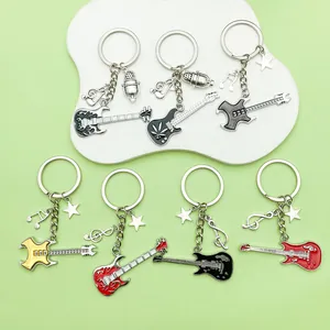 Detail view of various musical instrument keychains with guitar, note and microphone charms