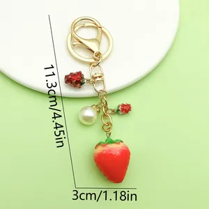 Detailed dimension view of a strawberry keychain featuring pearl and golden charms