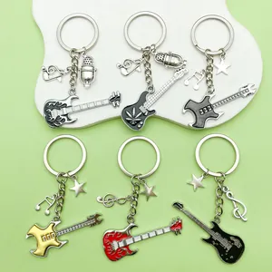 Music themed keychain set with guitar, microphone, and music note charms for bags