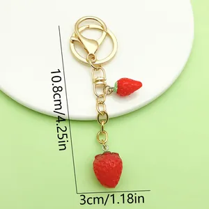 Detail view showing 10.8cm length of a cute red strawberry keychain with golden clasp