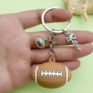 Detailed macro shot of a creative American football PVC keychain with metal charms.