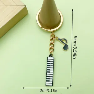 Piano keyboard keychain with musical note charm, 9cm total length measurement