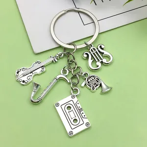 Close-up view of antique silver music keychain featuring saxophone and cassette charms