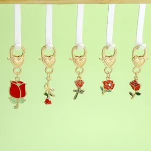 Macro view of five unique red rose alloy pendants for Valentine's Day keychain charms