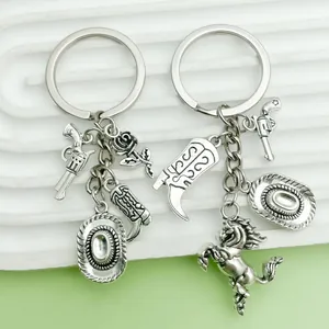 Detail shot of antique silver Western cowboy keychains with horse, boot and hat charms.
