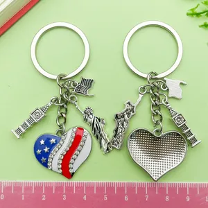Detailed view of American flag heart and Statue of Liberty charms on keychains