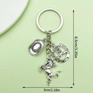 Detailed size view of an antique silver western cowboy hat and horseshoe horse keychain.