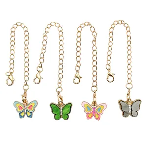 Detailed view of four colorful enamel butterfly charms with gold lobster clasp chains