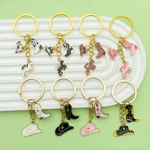Detailed view of western cowboy enamel keychains featuring hats, boots and horse charms.