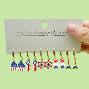 Detail view of a six-pair earring set featuring American flag and patriotic enamel charms