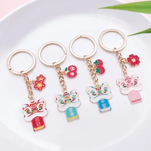 Detailed view of four colorful Chinese lion dance keychains with lucky characters.