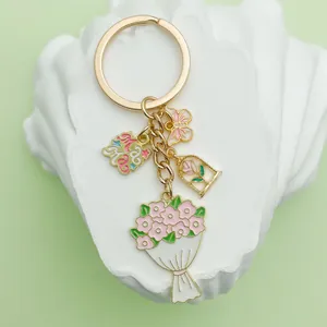 Detailed close-up of a Mother's Day keychain with pink enamel flower and butterfly charms