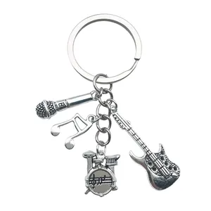 Musical instrument keychain featuring microphone, music note, drums, and guitar charms.