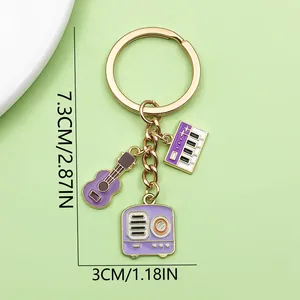 Music-themed keychain with guitar, piano, and radio charms, detailed size measurements.