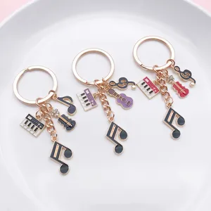 Detailed macro shot of musical instrument keychains with piano and guitar enamel charms