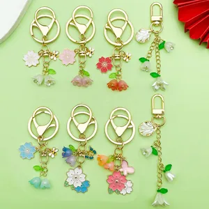 Collection of floral keychains with lily of the valley and cherry blossom charms.