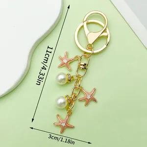 Gold-plated starfish and pearl keychain charm for bags 11cm total length with clip