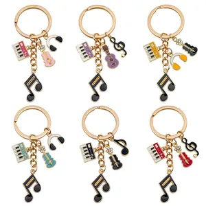 Collection of music-themed enamel keychains with piano and guitar charms in six colors.
