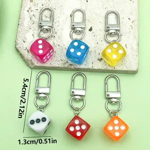 Detail showing colorful resin dice keychains with precise 1.3cm x 5.4cm dimension markings