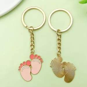 Cute baby footprint alloy enamel keychain charm with golden finish and pink details