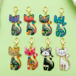 Macro shot of colorful cartoon cat alloy charms with lobster clasps for bag decor.