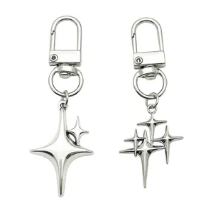 Detailed macro view of silver alloy keychains with modern four-pointed star pendants