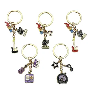 Collection of stylish music-themed keychains with guitar, piano, and note enamel charms