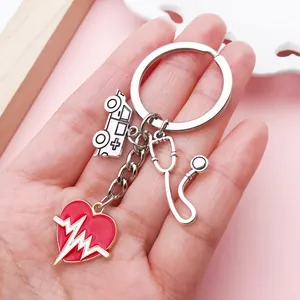 Close-up view of nurse-themed keychain with heart, stethoscope and ambulance charms