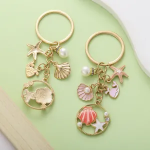 Close-up of ocean-themed alloy keychains with colorful shells, starfish and pearls