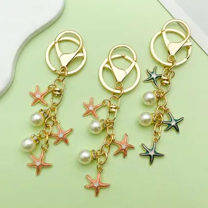 Close-up of handmade keychains with colorful starfish charms and elegant pearls
