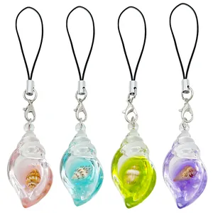 Detailed view of four colorful resin shell charms with tiny real seashells embedded inside