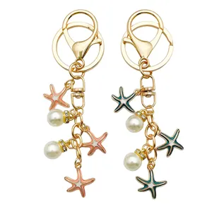 Detail view of golden starfish keychains with elegant pearls and sparkling rhinestones