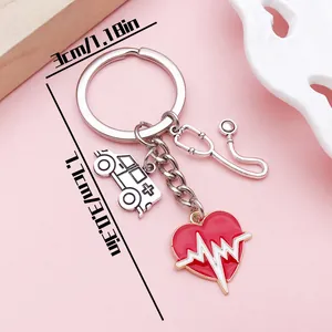 Close-up of a medical keychain with heart, stethoscope, and ambulance charms
