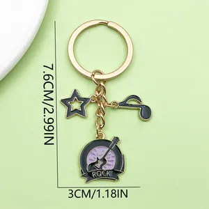 Detailed product view of music theme keychain with guitar and star charms measuring 7.6cm