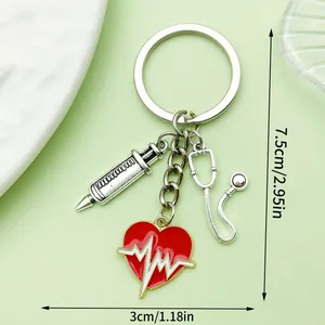 Medical themed keychain with red heart, syringe and stethoscope charms, 7.5cm size