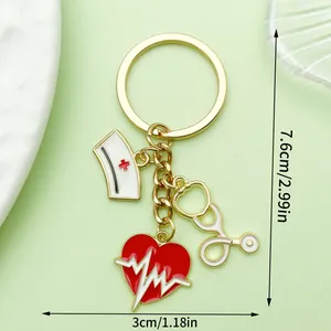 Medical theme keychain with heart, stethoscope, and nurse hat charms in gold finish