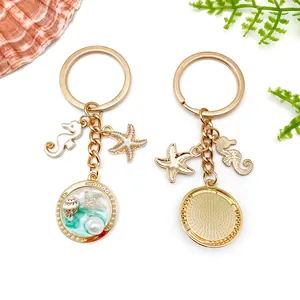 Detail view of gold ocean keychain with starfish, seahorse, and shell pendant.