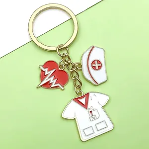 Detail shot of nurse-themed enamel keychain with heart, hat, and scrub charms.