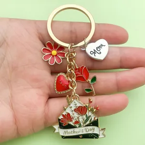 Close-up of Mother's Day keychain with Mom heart, rose, and flower charms on hand.