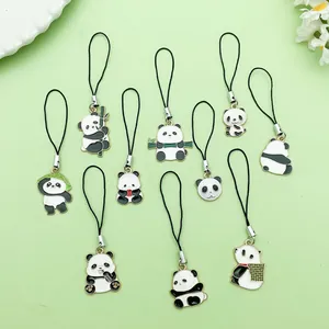 Close-up of a set of various cute panda enamel charms with black cords on a green base.
