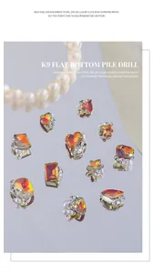 Close-up of Maillard style nail art charms with pearls and orange-red rhinestones
