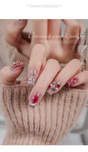 Close-up detail of Christmas themed nail art jewelry with pearls and zircons