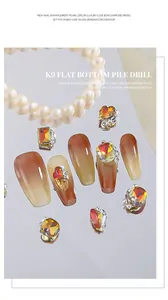 Close-up detail of luxury Maillard amber nail charms with pearl and zircon accents