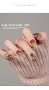 Detailed macro view of luxury heart-shaped rhinestone and pearl nail charm on brown manicure