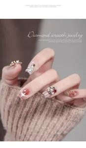 Macro view of luxury Christmas wreath and tree nail art charms with pearls and zircons