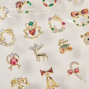 Sparkling Christmas zircon nail art charms with reindeer and bell designs in gold