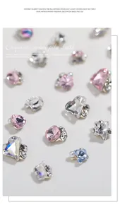 Macro detail of assorted heart and geometric nail art charms with pearls and zircons