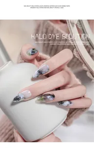 Detailed macro view showing artistic marble halo dyeing watercolor effect on long pointed fingernails