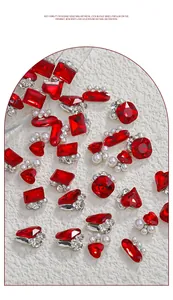 Close-up of sparkling Bordeaux red nail art rhinestones mixed with pearls and crystals